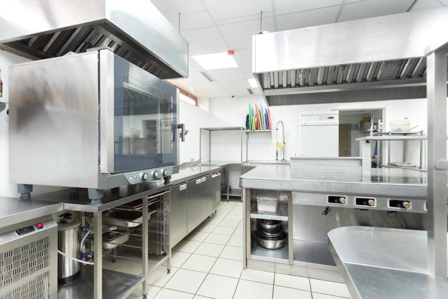 A spotless, well-organized commercial kitchen showcasing stainless steel appliances and countertops, highlighting the importance of deep cleaning commercial kitchens.